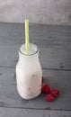 Kefir drink with raspberry on the gray background