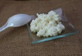 Kefir organic grains with a plastic spoon on linen canvas surface Royalty Free Stock Photo