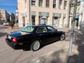 Kehl city street with old vintage Jaguar luxury car driving in front of