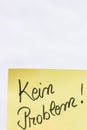 Kein problem no problem handwriting text close up isolated on yellow paper with copy space