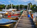 Kelantan, Malaysia -fishing boat near wooden jetty. Beautiful malaysian landscape. Sunset reflection in the water. Royalty Free Stock Photo