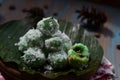 kelepon or klepon made from glutinous rice flour and filled with brownn sugar covered with grated coconut. indonesian food.