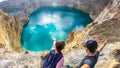 Kelimutu - A couple admiring the turquoise colored lake