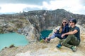 Kelimutu - A couple admiring turquoise coloured volcanic lakes