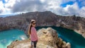 Kelimutu - A girl admiring turquoise coloured volcanic lakes