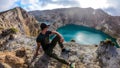 Kelimutu - A man admiring turquoise coloured volcanic lakes Royalty Free Stock Photo