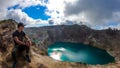 Kelimutu - A man admiring turquoise coloured volcanic lakes