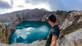 Kelimutu - A man admiring turquoise coloured volcanic lakes Royalty Free Stock Photo