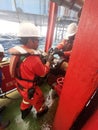Marine crew with full PPE connect cargo hose for jack up rig