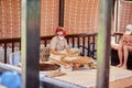 Kemer, Turkey - May 25, 2021: Woman prepares national Turkish food flatbread outdoors. Dough preparation. Turkish