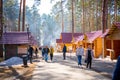 Kemerovo, Russia - April 16, 2022: People are walking in forest of open-air museum Tomsk pisanitsa located north-west of