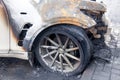 Kemerovo 2019-09-16 Wheel of white abandoned, stolen city car Infiniti FX50S burned out, suddenly started engulfing all Royalty Free Stock Photo
