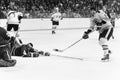 Ken Hodge puts a shot on Canucks goalie.