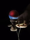 Kendama japanese toy in black background in hand