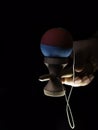 Kendama japanese toy in black background in hand