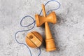 Kendama Japanese wooden toy with blue thread on a concrete background