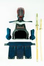 Kendo - Kendoka armor and equipment arranged and displayed on white background, with shinai and wooden sword. Royalty Free Stock Photo