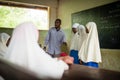 Students with teacher during English lesson, Zanzibar