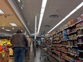 Kenmore, WA USA - circa March 2021: View of an elderly man shopping in the ethnic food aisle inside QFC