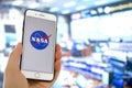 A person holding a iPhone with the NASA logo with a out of focus Royalty Free Stock Photo