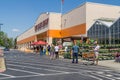 Home Depot line outside the store with masked people practicing social distancing 6 feet apart during Covid-19 Corona Virus