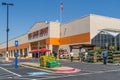 Home Depot line outside the store with masked people practicing social distancing 6 feet apart during Covid-19 Corona Virus