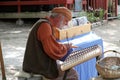 Medieval dressed musician performs on a string percussion instrument at the annual Bristol Renaissance