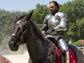 An actor as medieval knight demonstrate skills on horseback at the annual Bristol Renaissance Faire Royalty Free Stock Photo