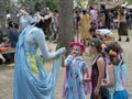 A beautiful girl dressed as a fairy play with children at the annual Bristol Renaissance Faire Royalty Free Stock Photo