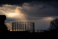 Kensal Green gasometer silhouetted in front of angry sky