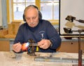 KENTSHIN, POLAND. A male glassware heats a glass blank on a gas burner. Christmas tree toy factory