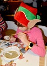 KENTSHIN, POLAND. A left-handed girl paints a tree toy. Children `s master class in the workshop
