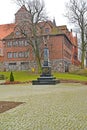 KENTShIN, POLAND. An obelisk `Memories of the died Poles 1939 - 1956` against the background of a church St. Hedgehogs