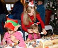 KENTSHIN, POLAND. A teacher shows a girl painting a tree toy. Children `s master class in the workshop
