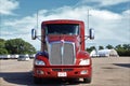 A KENWORTH semi Tractor in a parking lot with sky and clouds