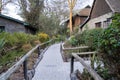 Walkway to huts and buildings on the grounds of Lake Nakuru Lodge, a safari hotel near the national