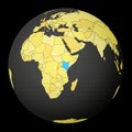 Kenya on dark globe with yellow world map.