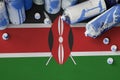 Kenya flag and few used aerosol spray cans for graffiti painting. Street art culture concept