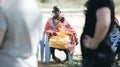 KENYA, KISUMU - MAY 20, 2017: African woman from local maasai tribe sitting on chair and hold balloon.