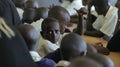 KENYA, KISUMU - MAY 23, 2017: Close-up view of three african boys in uniform sitting in classroom in school