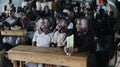 KENYA, KISUMU - MAY 20, 2017: Group of happy African children sitting in classroom and smiling, laughing together.