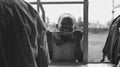 KENYA, KISUMU - MAY 20, 2017: Portrait of little african boy smiling, holding on lattice. Cute male spending time