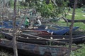 KENYA, KISUMU - MAY 20, 2017: Two african man preparing his boat before work. People taking shower in the lake.