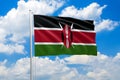 Kenya national flag waving in the wind on clouds sky. High quality fabric. International relations concept