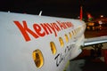 Kenya Airways airplane on ground. View from the front of vehicle, windows and wings in center