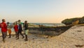 Kenyan children at fishing boat sunset view