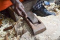 Kenyan sculptor sharpening a chisel Royalty Free Stock Photo