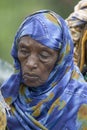 A Kenyan woman with a blue scarf stands in line at the Pepo La Tumaini Jangwani, HIV/AIDS Community Rehabilitation Program, Orphan Royalty Free Stock Photo