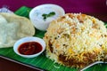 Kerala biryani thali served with curd and papad