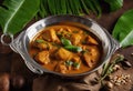 Kerala fish curry Alappuzha India. Hot and spicy homemade red fish Masala curry banana leaf background. King fish coconut milk